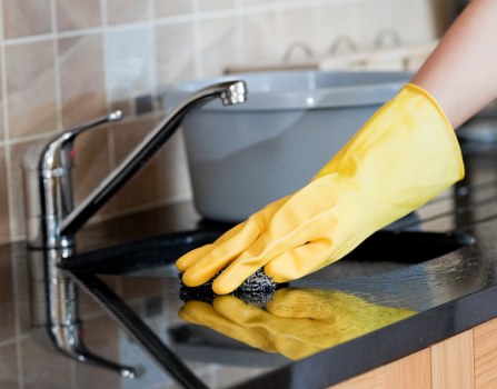 Local upholstery cleaner treating stains on a sofa in SE5